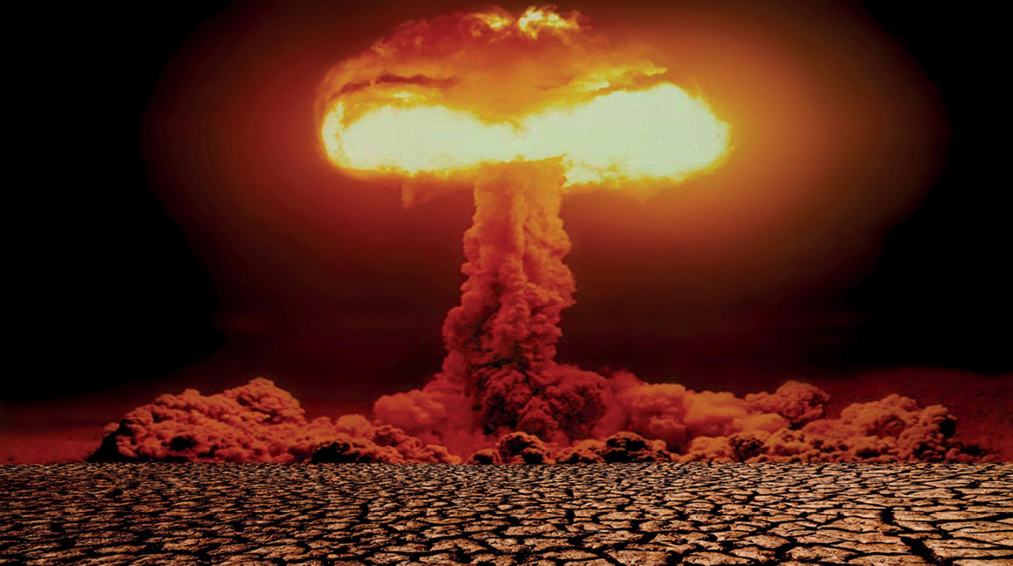 Nuclear explosion with mushroom cloud on scorched earth