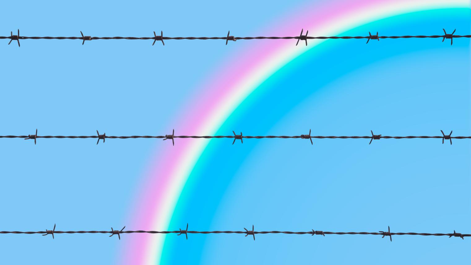 A barbed wire fence with a rainbow.