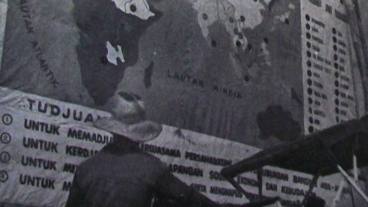 "A 'Betjak' driver reads one of the Conference posters." Page 11 of the Asian-African Conference Bulletin, No. 9. April 25, 1955; published by the Indonesian Ministry of Information. Sourced via Wikipedia Commons.